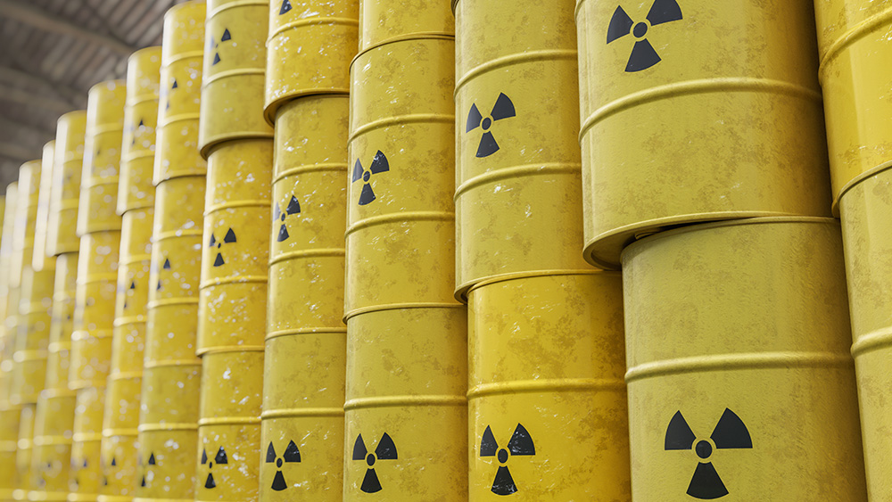 Barrels containing nuclear waste that are stacked on each other.