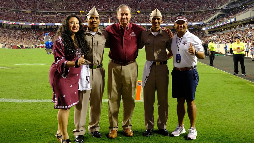 Col. Rosendo Guieb standing on Kyle Field with his family
