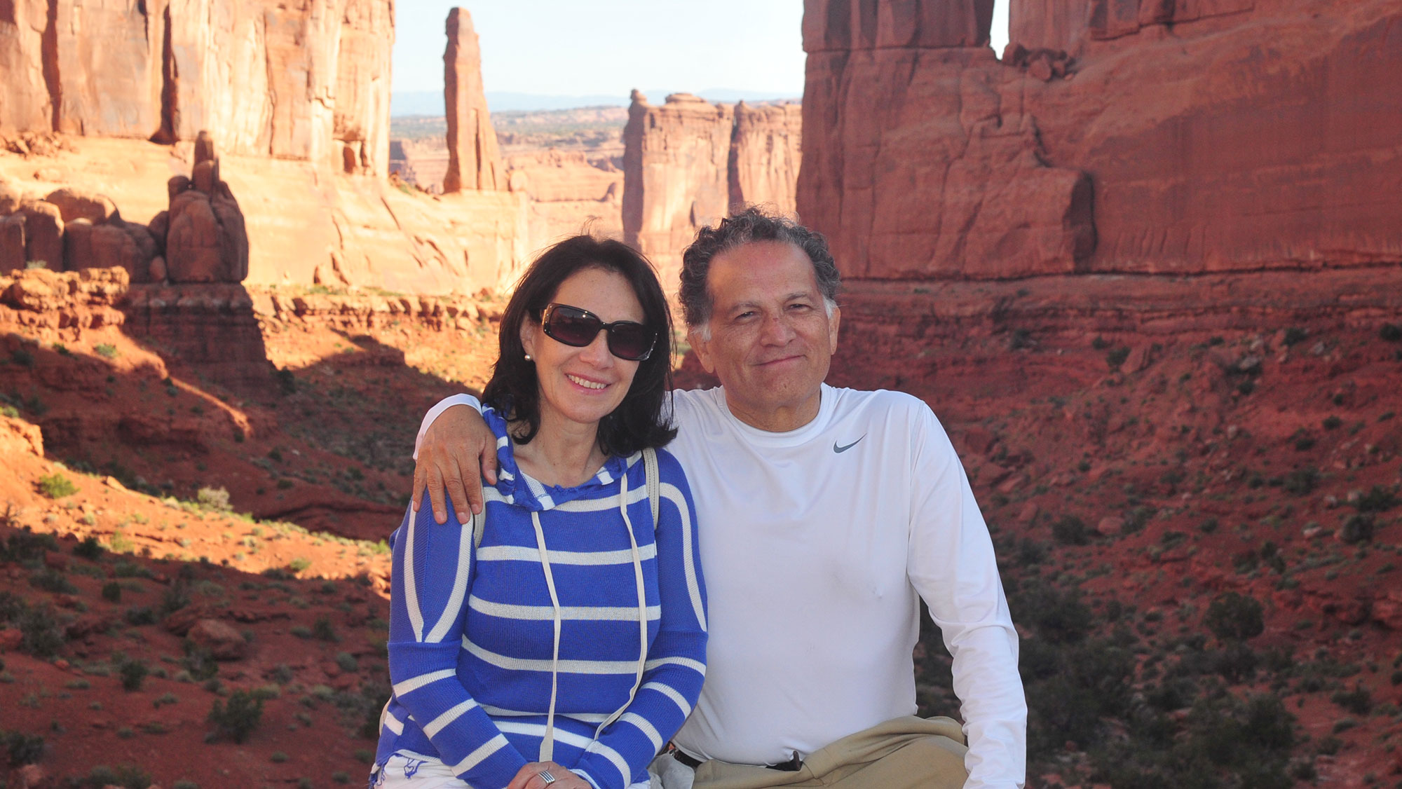 Dr. Edgar Sanchez-Sinencio and wife Yolanda pose in front of a canyon