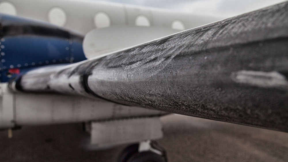Ice formation buildup on the front of an airplane wing.
