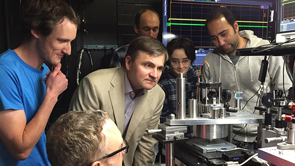 Dr. Vladislav Yakovlev with researchers in optics lab.