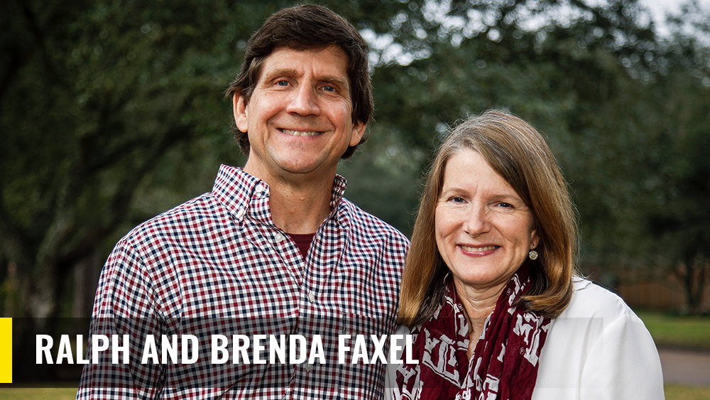 Brenda F. and Ralph Faxel Jr. standing outside in front of a tree