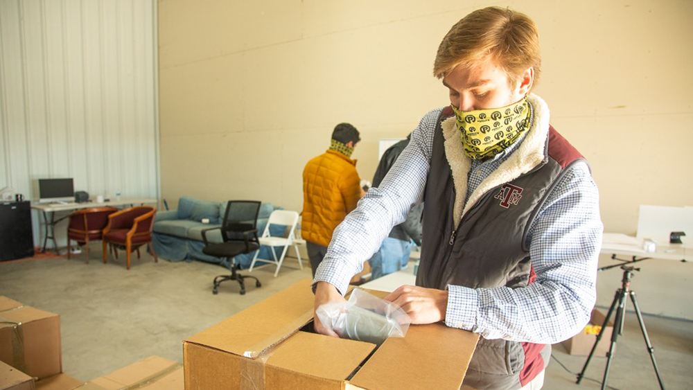 Texas A&amp;M student Austin Burt boxes orders at the SanitaryPull warehouse in Bryan.