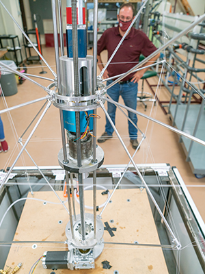 Dr. Eduardo Gildin reviews tensegrity drilling rig created by Aggie student engineering team for the 2020 NASA Moon to Mars Ice and Prospecting Challenge