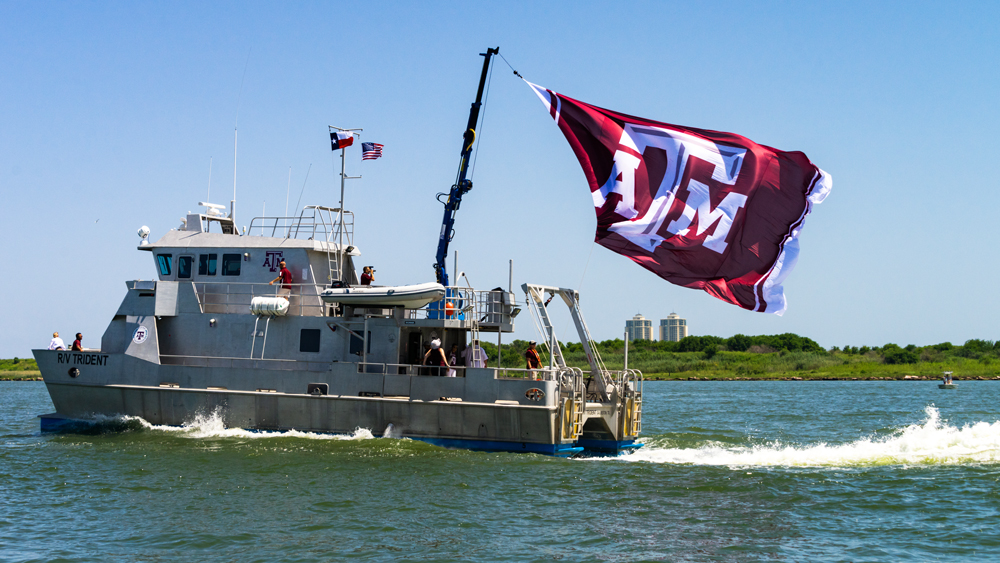The R/V Trident sailing with a Texas A&M flag