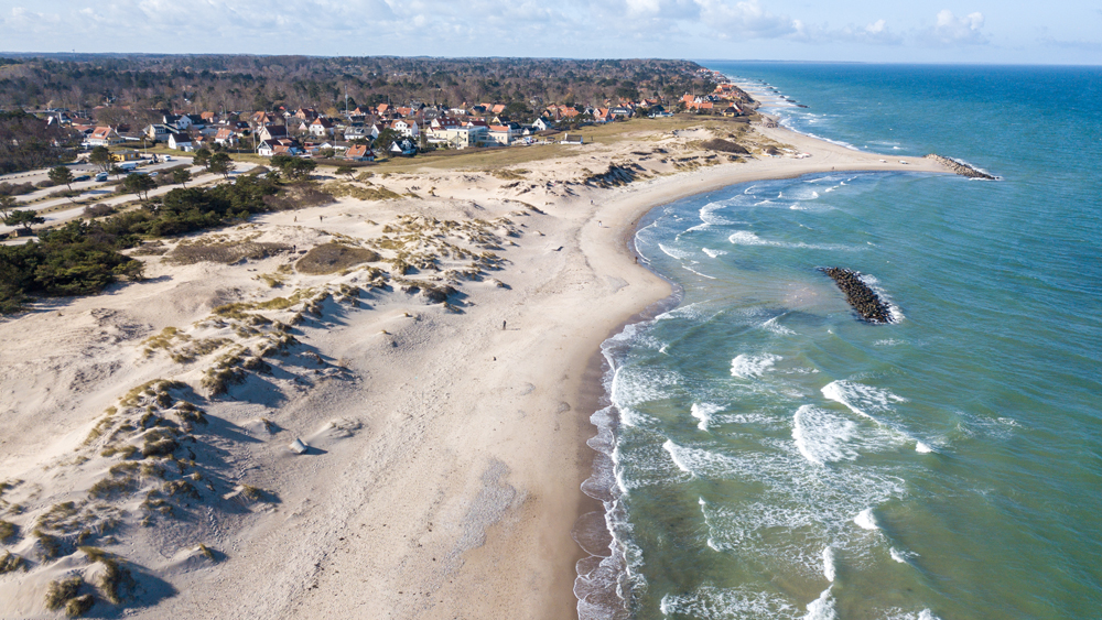 A coastline with dunes, barrier islands and a coastal community