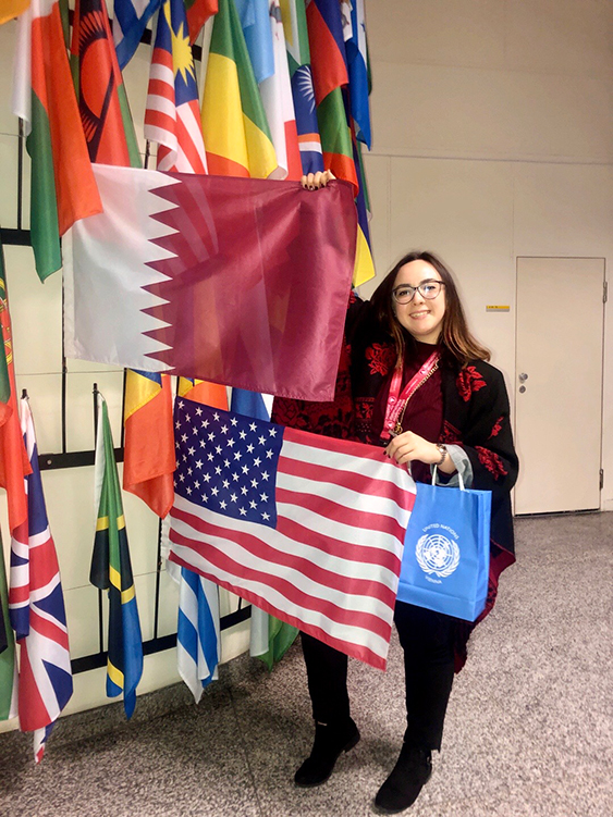 Sara Amani holding the American flag and the Qatar flag 