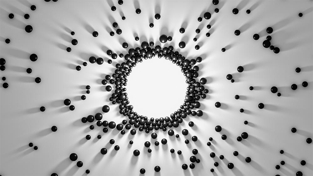 Abstract of small black spheres converging into the shape of a circle