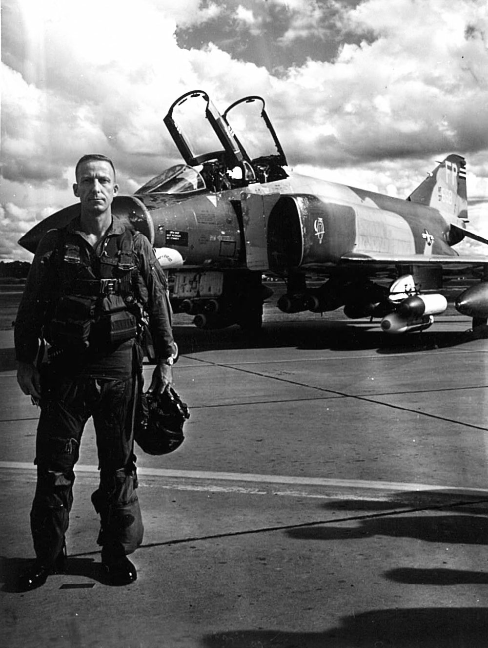 Black and white photo of a pilot standing in front of an F-4 Phantom fighter bomber.