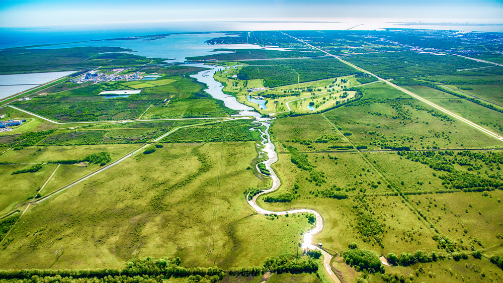 A bayou cutting into the rural farmland of East Texas near the Gulf of Mexico coastline