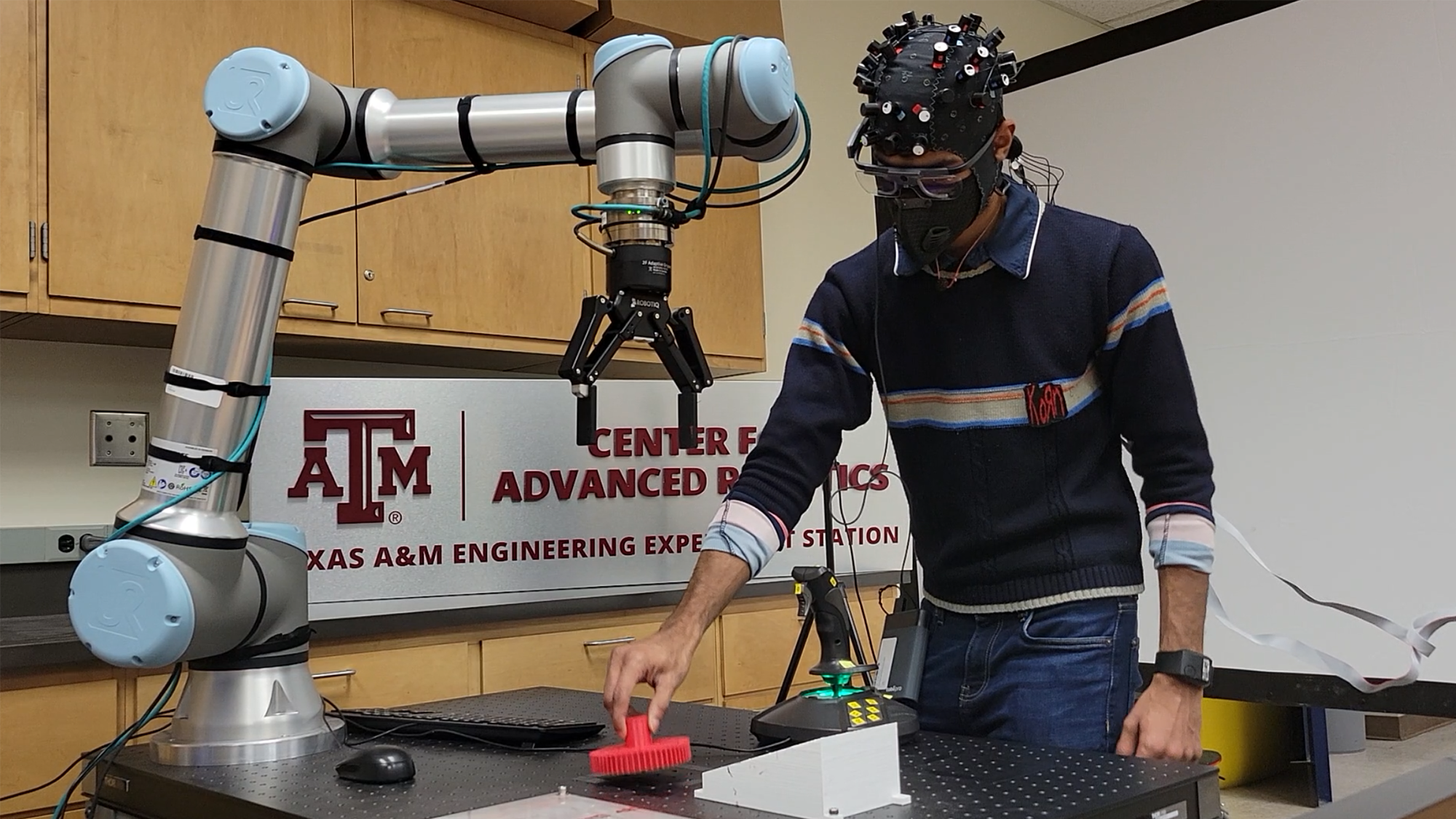 Doctoral student, Adithyaa Karthikeyan, works on an experiment assembling a gear system to better understand the decision-making process of a subject. 