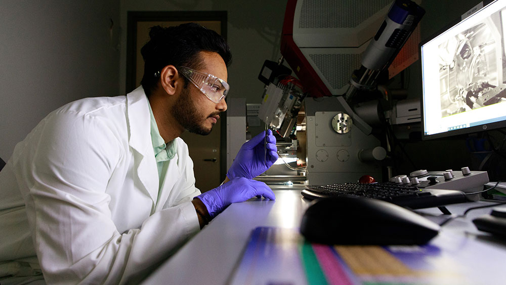 Hemant Rathod observes a sample of chromium aluminum carbide before loading it into the scanning electron microscope.