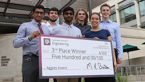 Sensory Overload, the third-place team from Aggies Invent, holding a $500 giant check. 