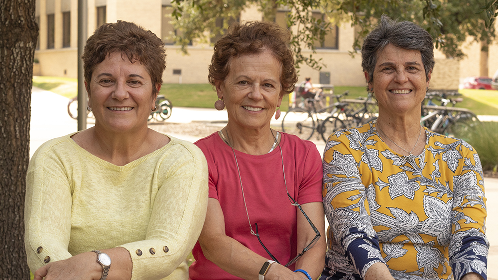 Rosana Moreira, Maria Barrufet and Elena Castell-Perez smiling and seated outdoors on Texas A&amp;M University campus 