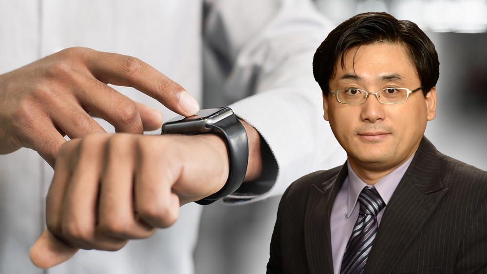 Dr. Choongho Yu in front of an image of a man wearing a smart watch.