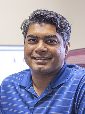 Dr. Siddharth Misra, smiling and seated in an office chair