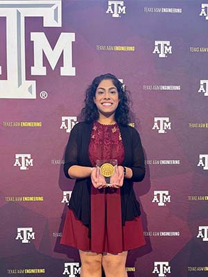 Jainita Chauhan in front of a Texas A&amp;M backdrop. 