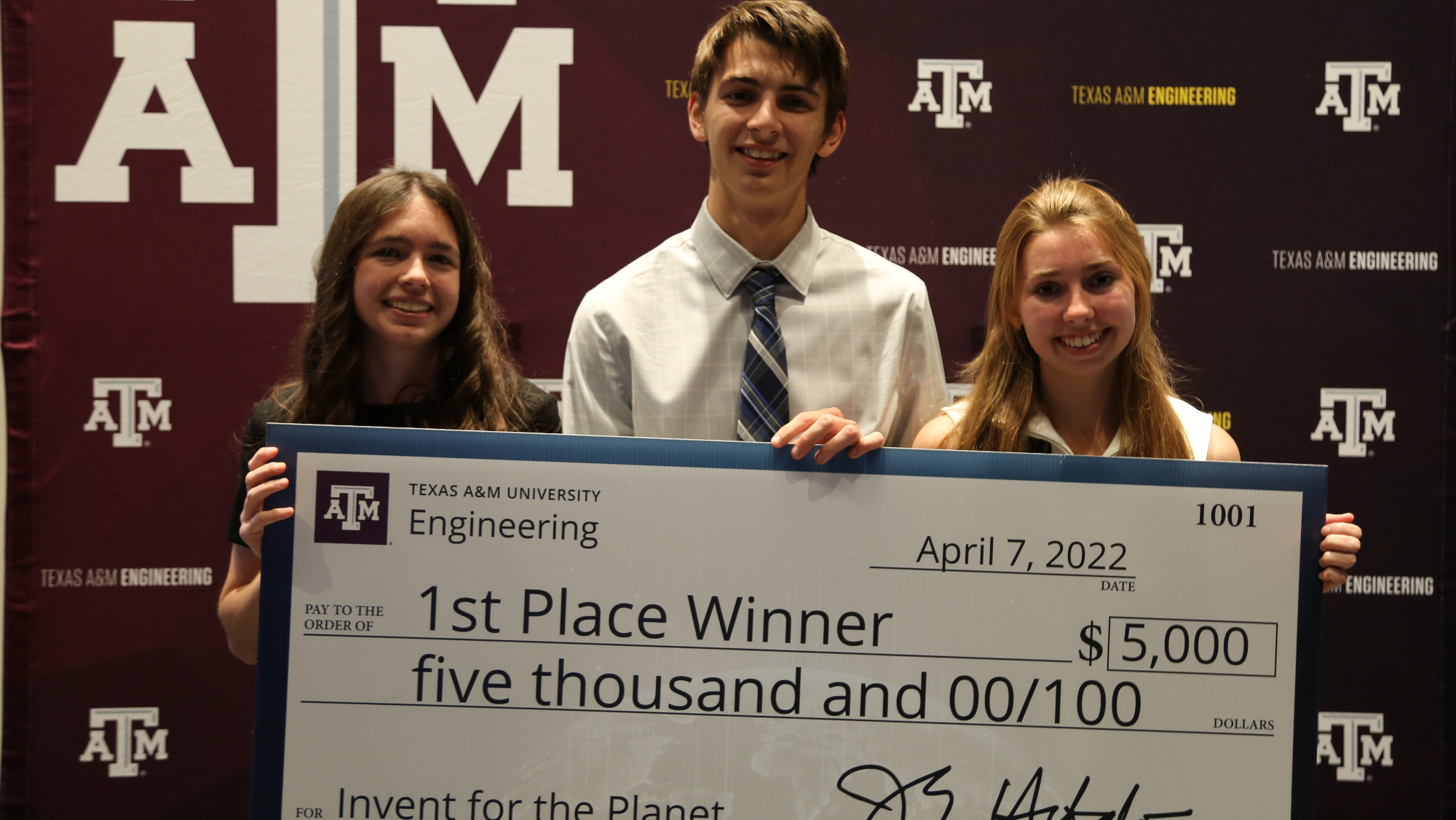 Texas A&M University's team, Aquabox, accepted their $5,000 check for placing first in the Invent for the Planet finals.