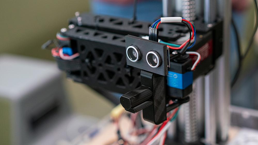 Close up of a prototype autonomous electric vehicle charging arm.