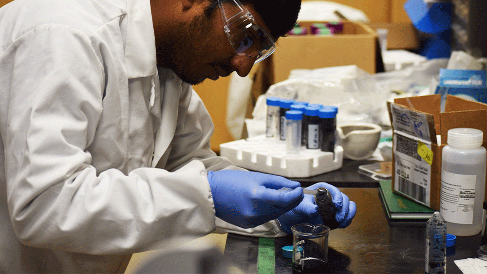 Graduate student Kailash Arole uses electrochemical exfoliation to separate graphene from petroleum coke.