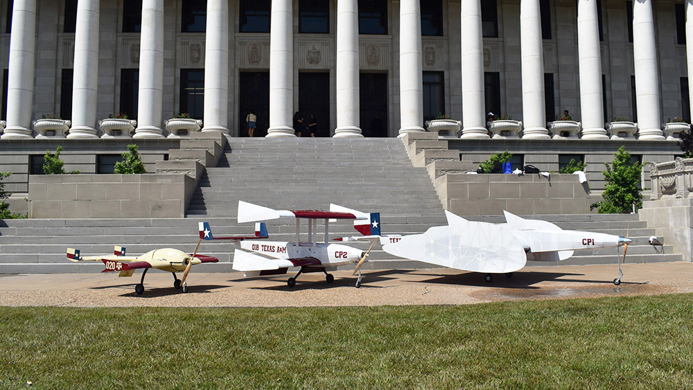 Three student-designed aircraft lined up in front of the administration building on Texas A&amp;M University's campus.