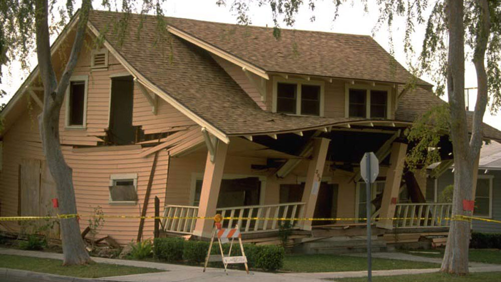 Wooden house damaged by earthquake 