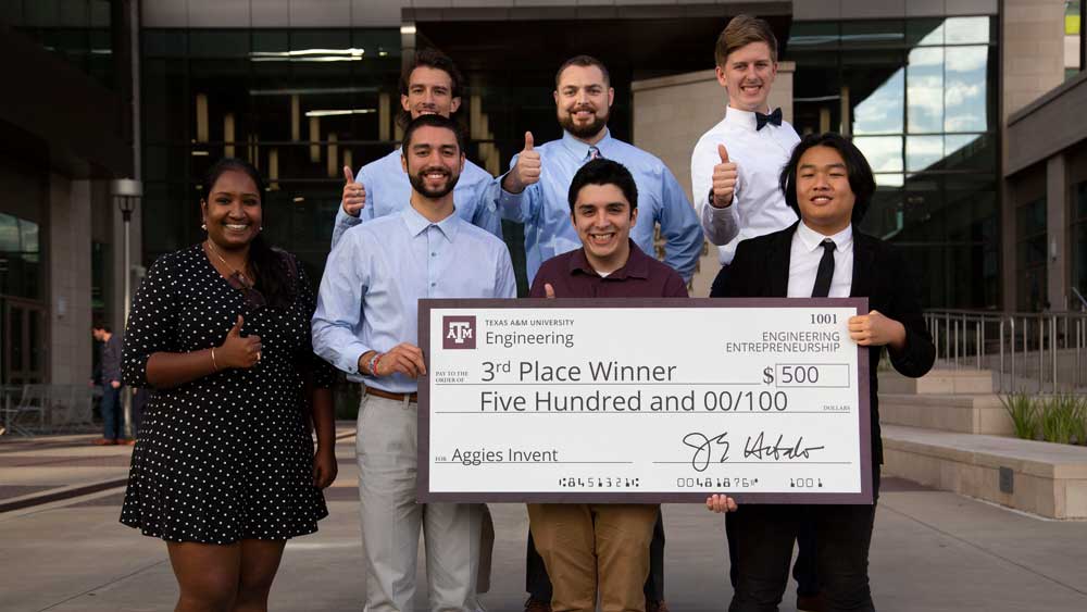 Third-place team Fog poses with their advisor at Aggies Invent.