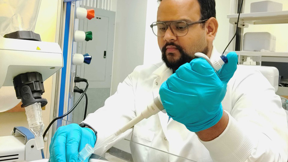 Student researcher Anirudh Gairola using a pipette in the lab at Texas A&M. 