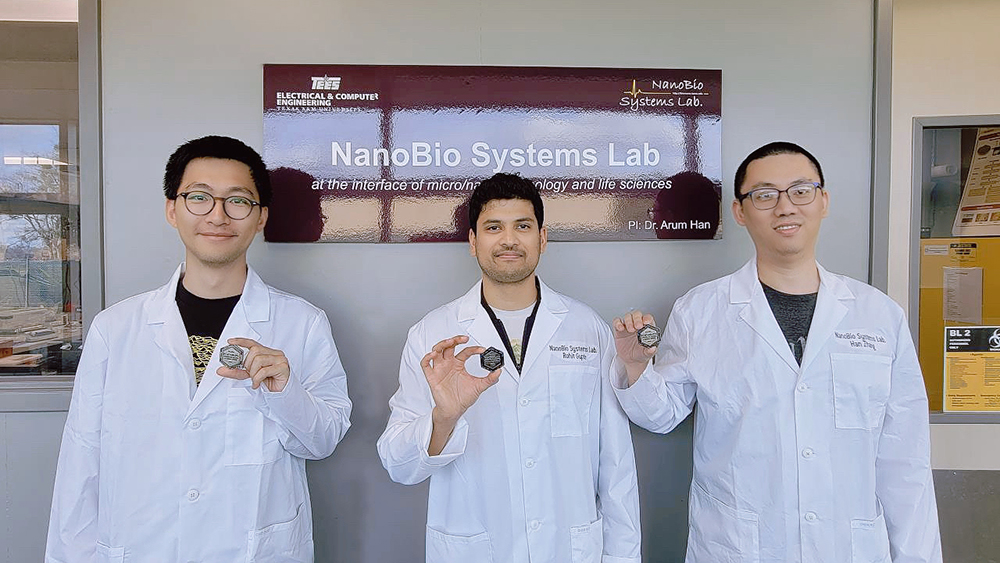 Can Huang, Rohit Gupte and Han Zhang standing in front of NanoBio Systems Lab holding award
