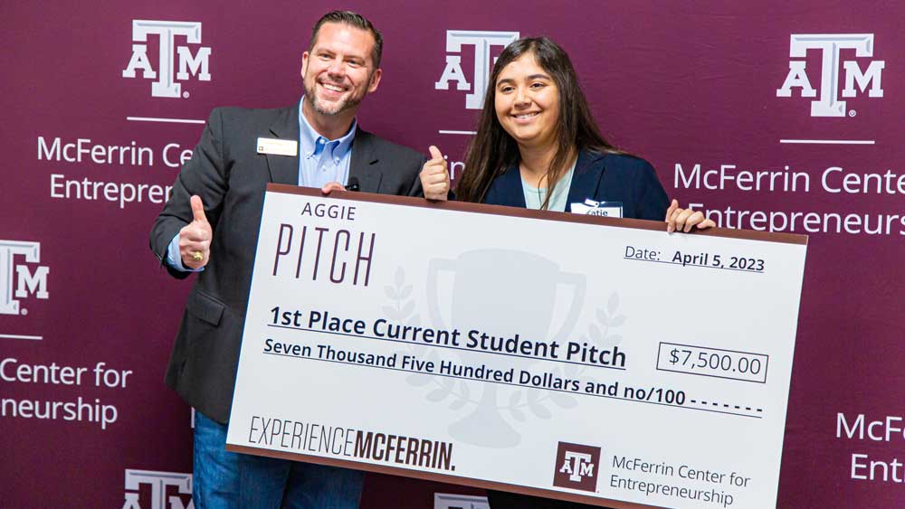 Blake Petty and Katie Calderon hold an oversized check for $7,500 for the first-place current student pitch.
