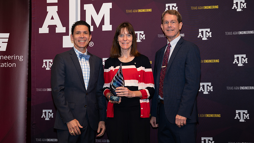 From left, Dr. John E. Hurtado, Dr. Karen Kirkland holding her award and Dr. Harry Hogan