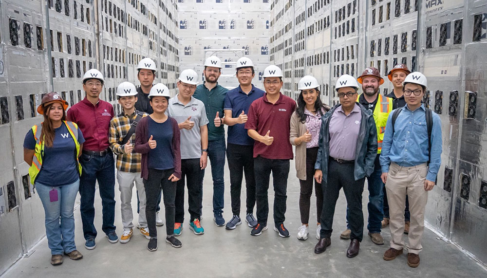 The Texas A&amp;M Blockchain and Energy Research Consortium team standing in Riot’s Rockdale Facility.