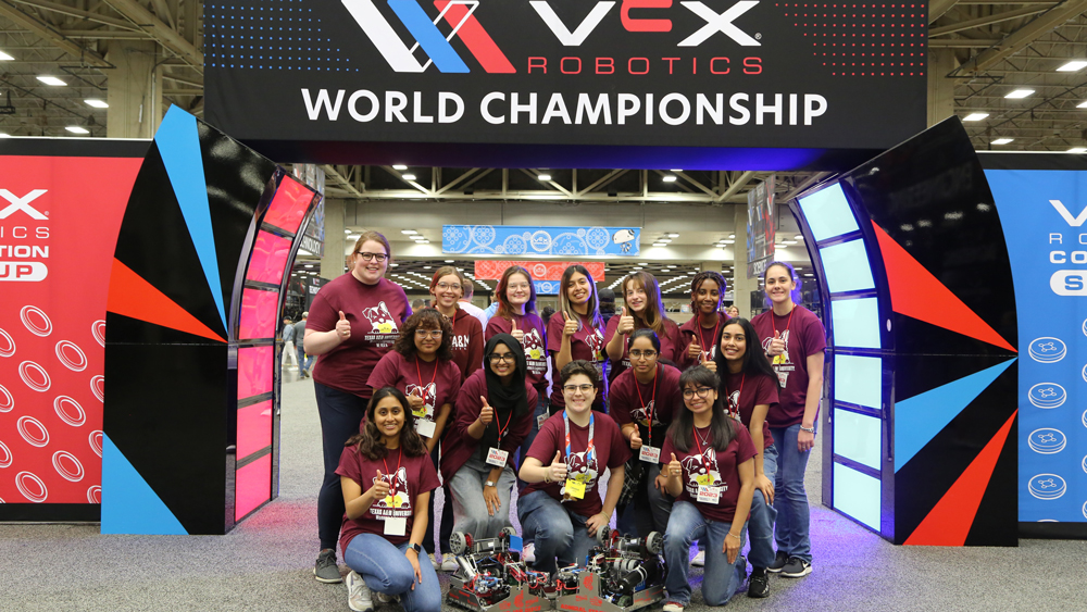 Robotics team WE VEXU members with their two robots used in the 2023 VEX Robotics World Championship.