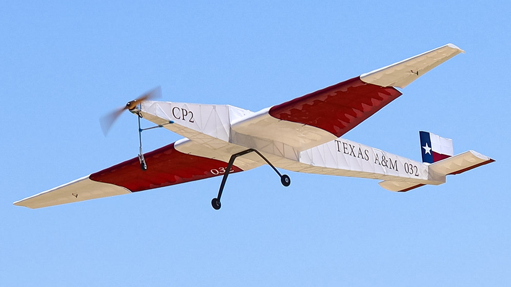 The maroon and white Regular Class airplane flying in the sky.