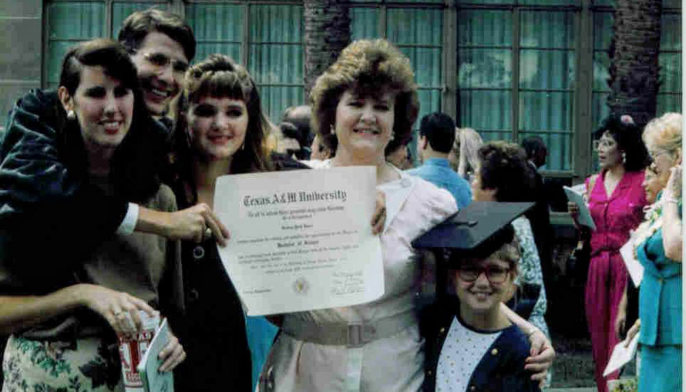 Paul Deere (second from left) standing with his family holding his diploma from Texas A&amp;M University