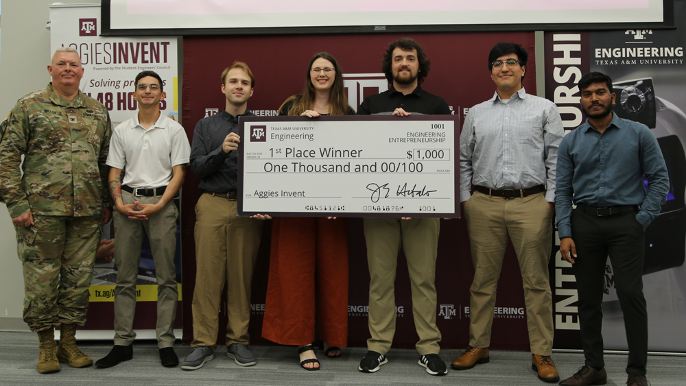 Team HitchHawk with their first-place jumbo check for $1,000.