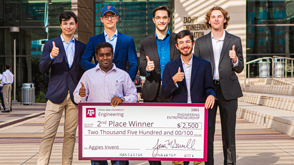 Aggies Invent Sandia's second-place winning team with their jumbo check for $2,500.