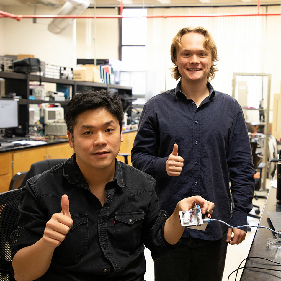 Peng-Hao Huang and Nicholas Heinrich-Barna smiling in a lab.