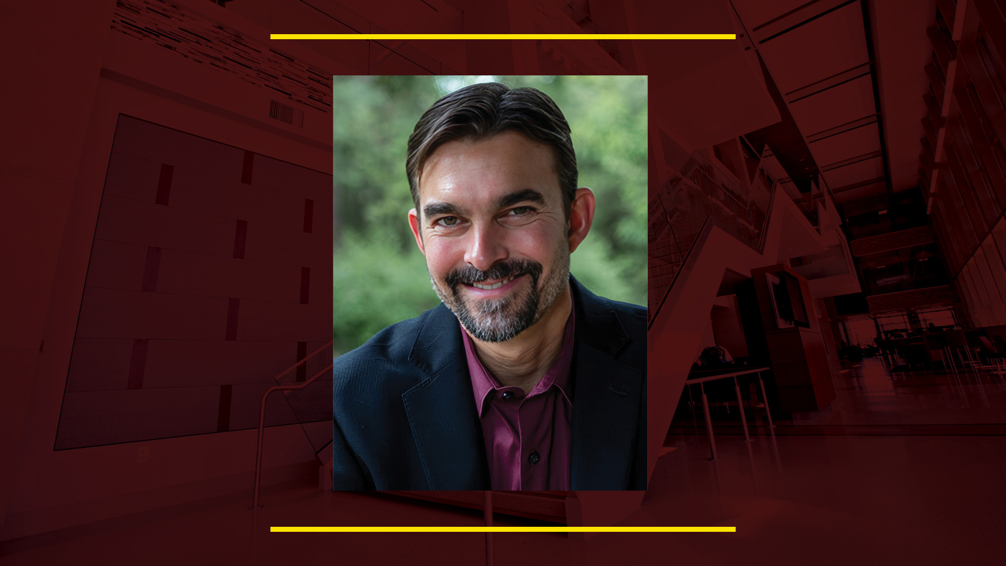 Headshot of Dr. Mike McShane on a maroon background.