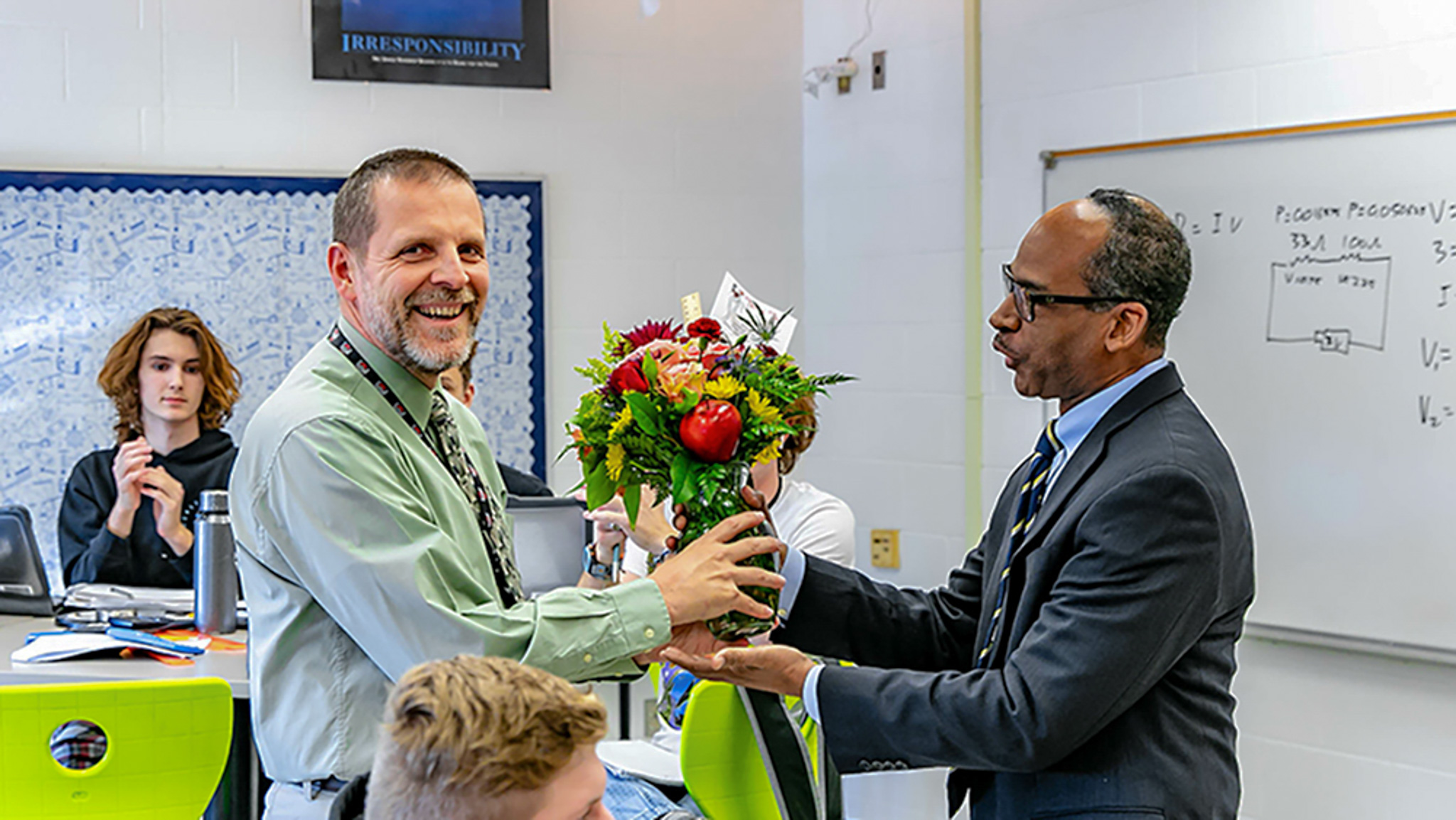 Scott Graham ’00 being presented flowers by superintendent Dr. Theo Cramer.