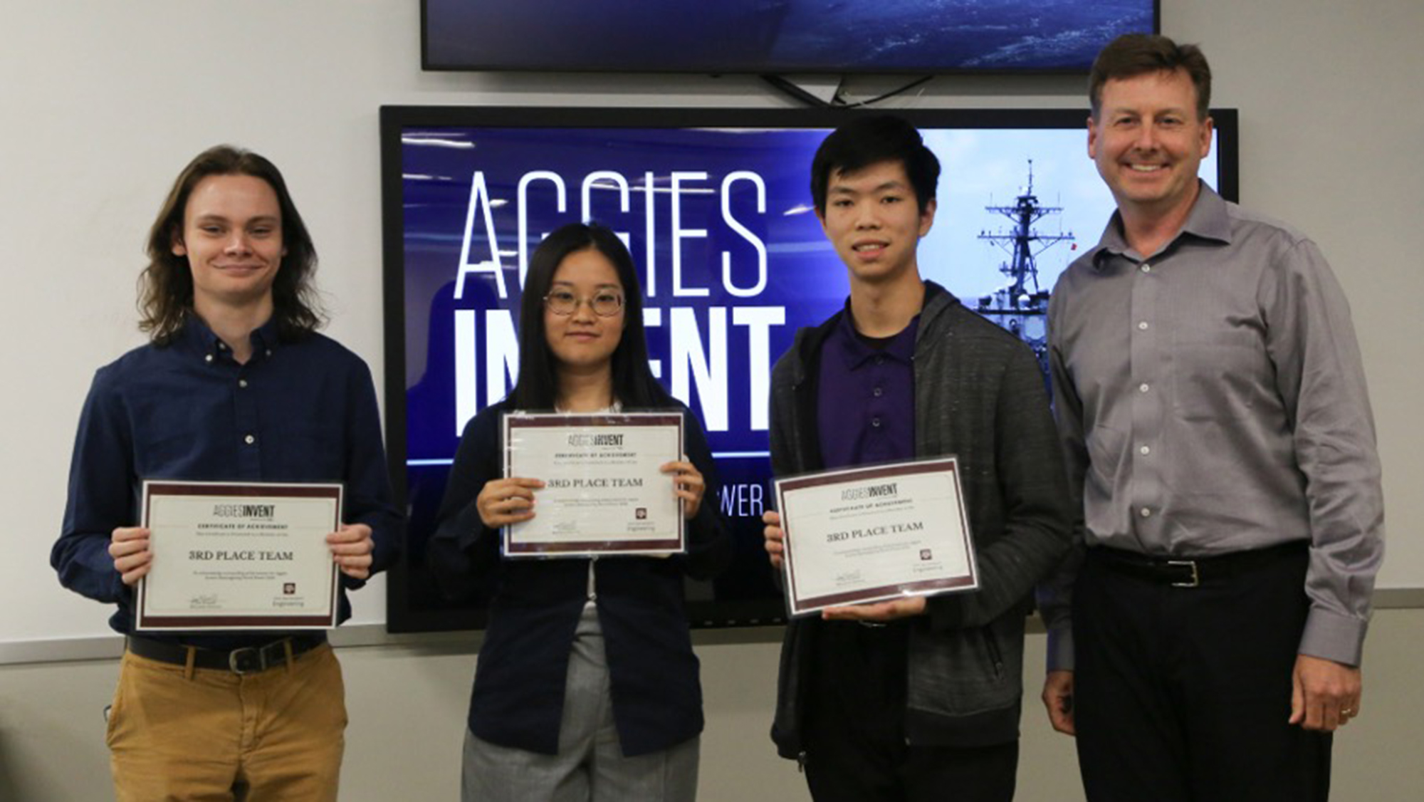 Winning students holding third place certificates.