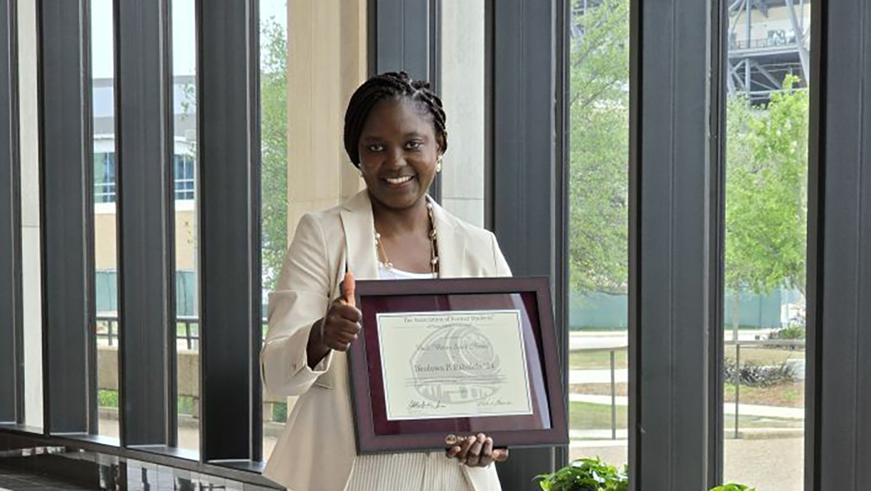 Woman holding a plaque. 