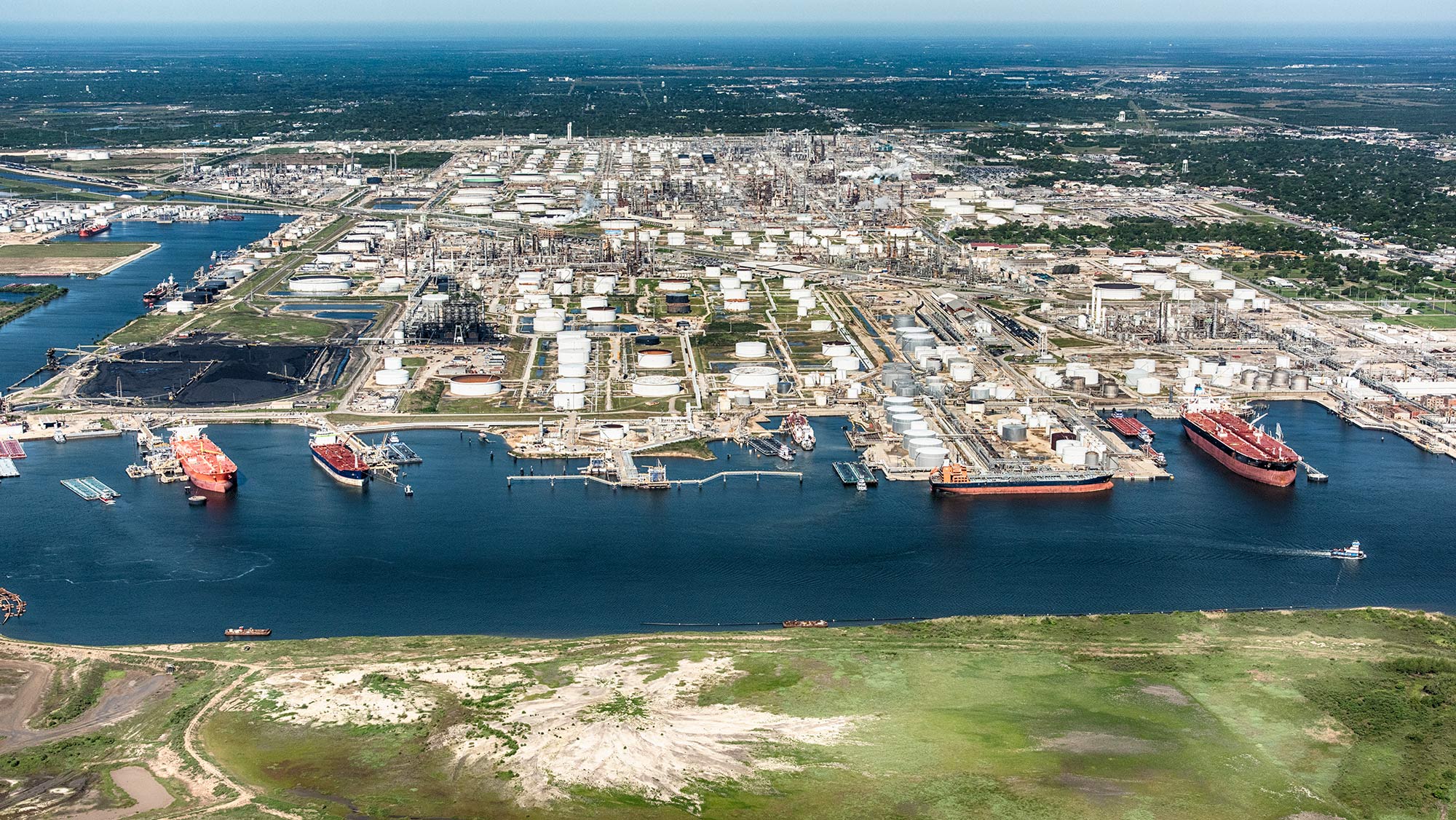 Aerial view of tankers docked at an industrial seaport.