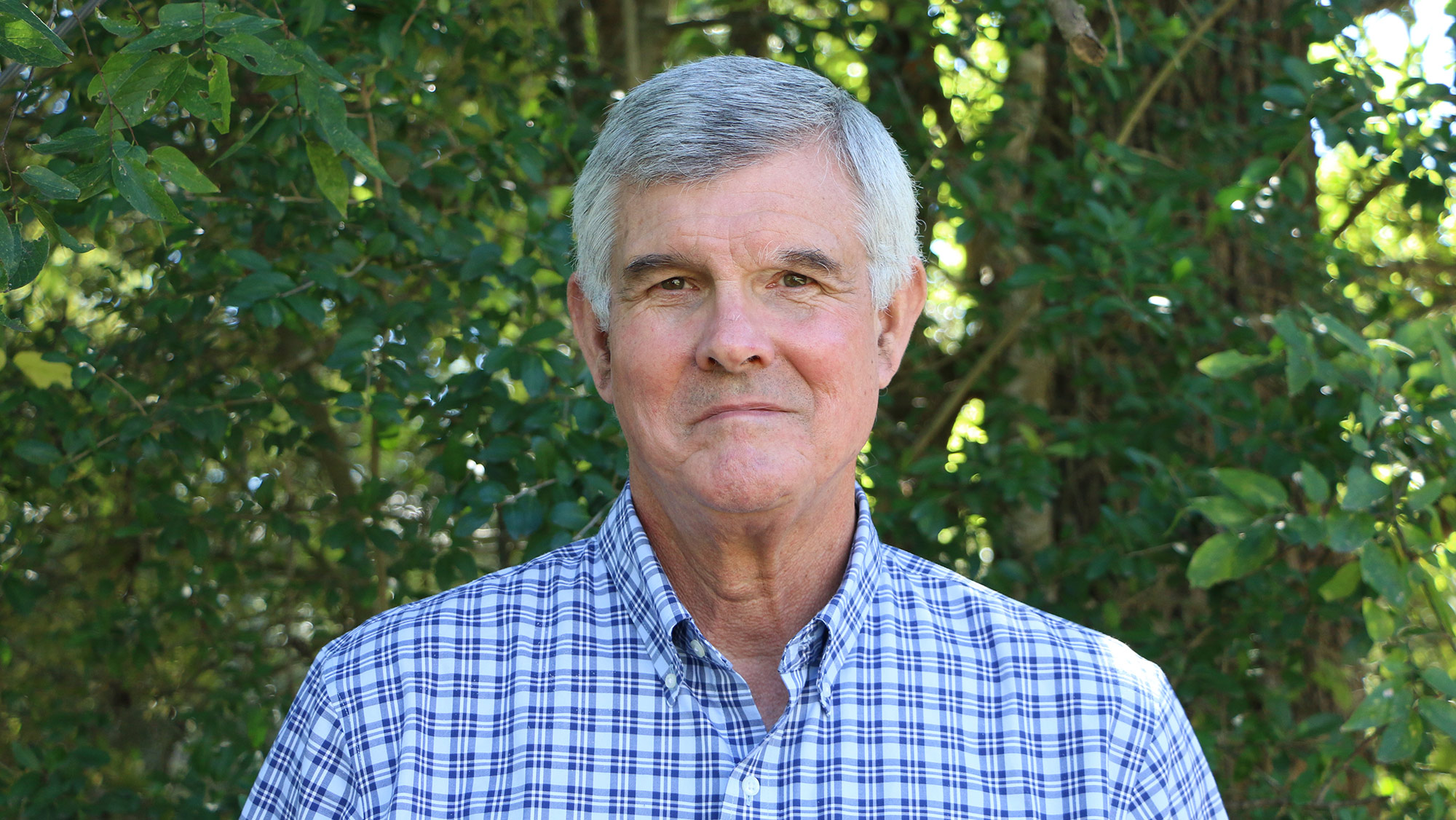 A man in a blue checkered shirt.