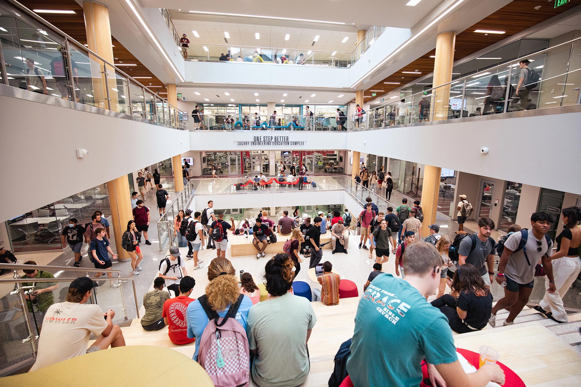 People walking in a crowded staircase.