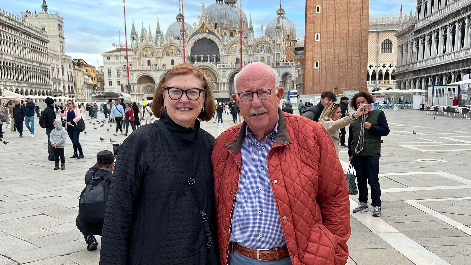 Man and woman in front of a Cathedral.