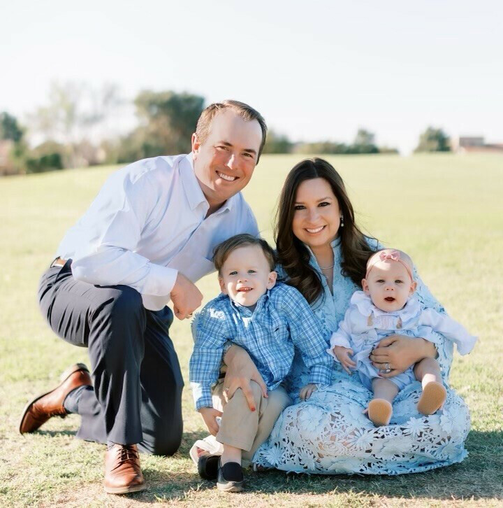  Man and woman smiling with their two children