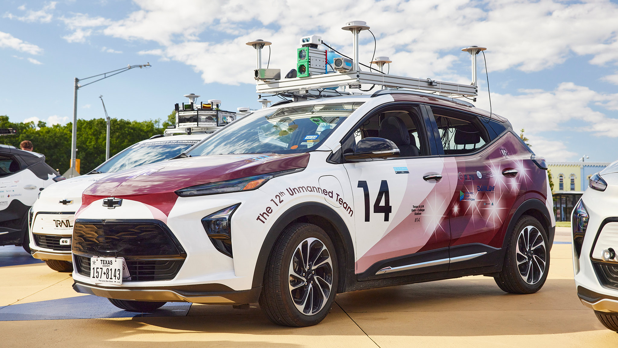 A self-driving test vehicle with sensors and equipment mounted on the roof.