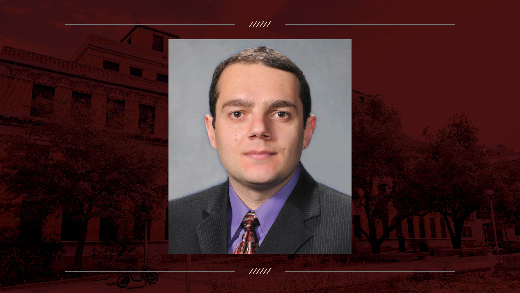 Headshot of a person on a maroon background.