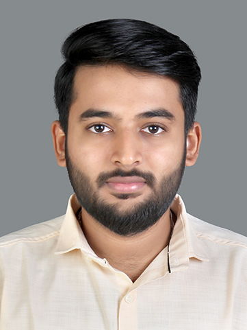 A man’s headshot wearing a light-colored shirt and facing the camera.  